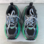 Unisex sneakers back view, black heel counters with green edge trim and blue lace accents.