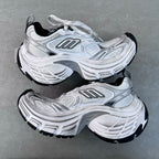 Balenciaga unisex sneakers angled pair, light gray uppers with black outsole edges
