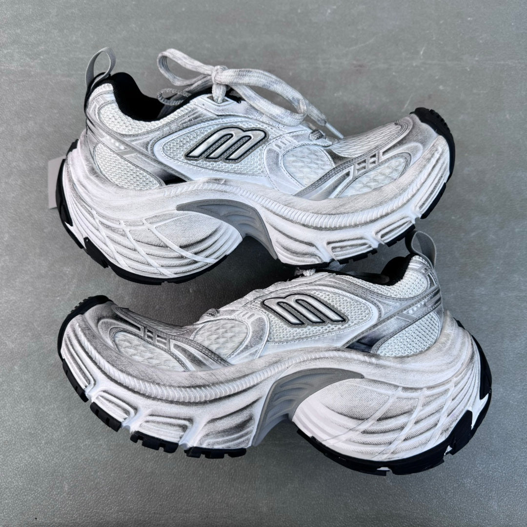 Balenciaga unisex sneakers angled pair, light gray uppers with black outsole edges