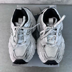 Balenciaga unisex sneakers pair, light gray uppers with black interior and laces