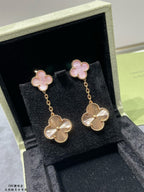 Gold-tone dangling earrings with pink clover tops and scalloped flower drop charms in box