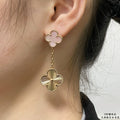 Gold-tone clover stud earrings with long chain and scalloped flower drop on ear