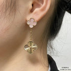 Gold-tone clover stud earrings with long chain and scalloped flower drop on ear
