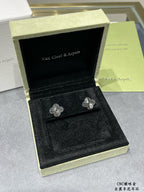 Quatrefoil stud earrings in black display box, silver-tone floral motif