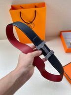 Hermes belt with dark blue strap and red underside, buckle with gold patterned insert