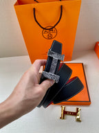 Hermes belt with dark blue textured leather, red underside, and gold-tone buckle pieces