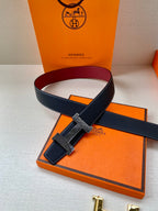 Hermes belt laid flat with dark blue leather strap and gold-tone buckle detail