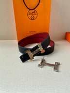 Hermes belt with dark blue leather and red lining, crosshatched buckle accent