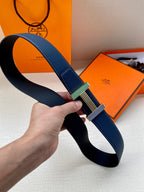Blue leather belt looped, striped green-and-gold buckle at center
