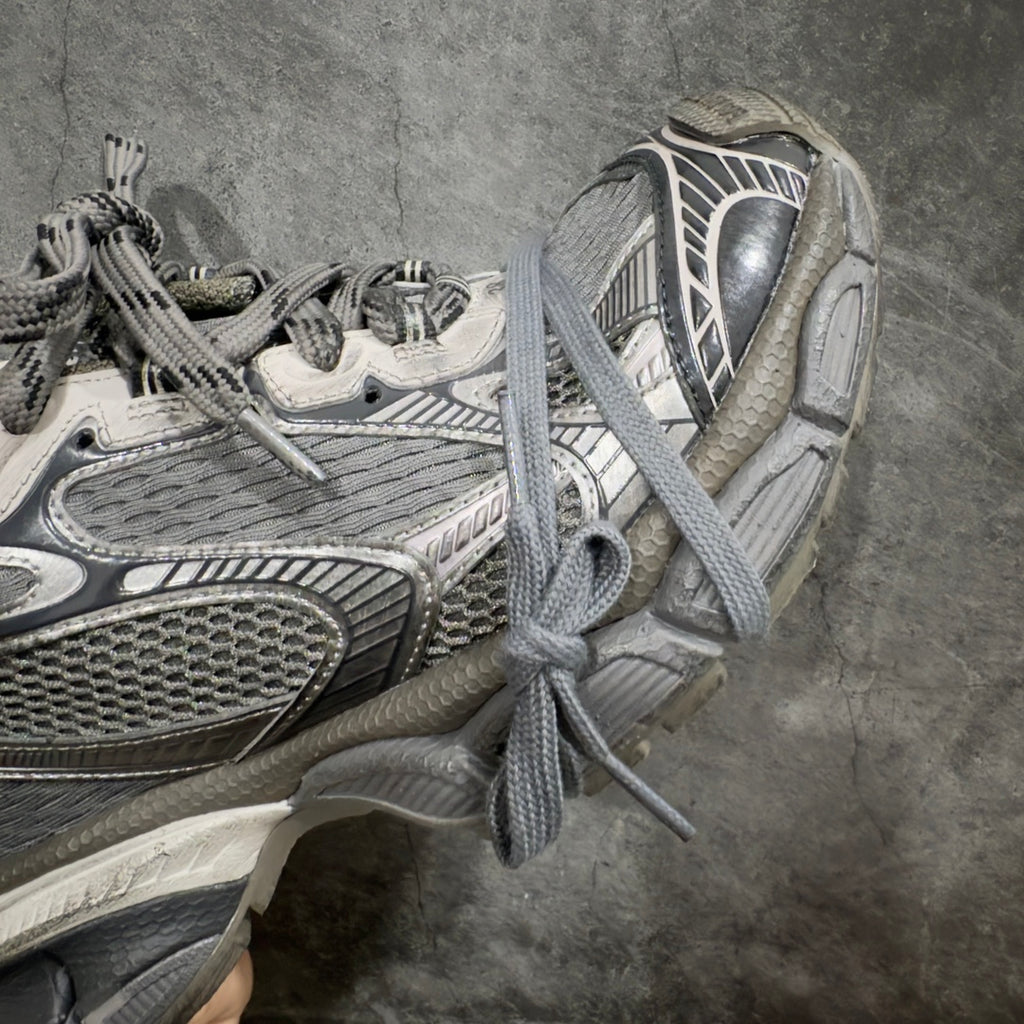 Balenciaga sneakers close side view, gray laces, padded collar, mesh upper