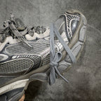 Balenciaga sneakers close side view, gray laces, padded collar, mesh upper