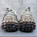 Unisex sneakers heel view, thick lug soles and light gray uppers with lace-up ties.