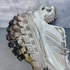 Unisex sneaker heel and side, light gray mesh and leather with deep lug rubber outsole.