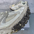 Unisex sneaker side view with textured panels, lace-up closure, and heavy traction tread.