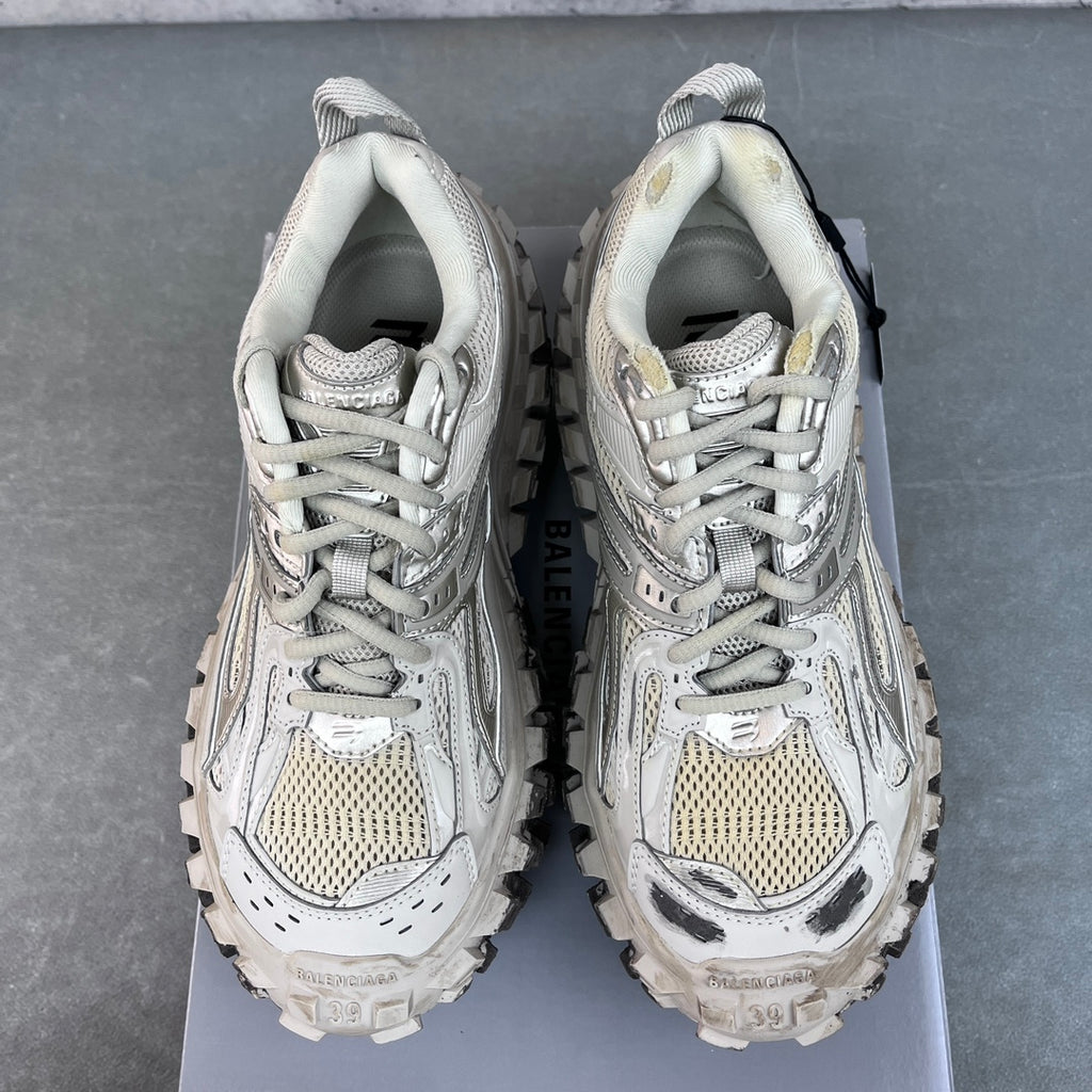 Unisex sneakers front view, light gray uppers with lace-up closure and rugged lug soles.