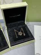 Van Cleef & Arpels accessories: clover pendant necklace and drop earrings in gift box