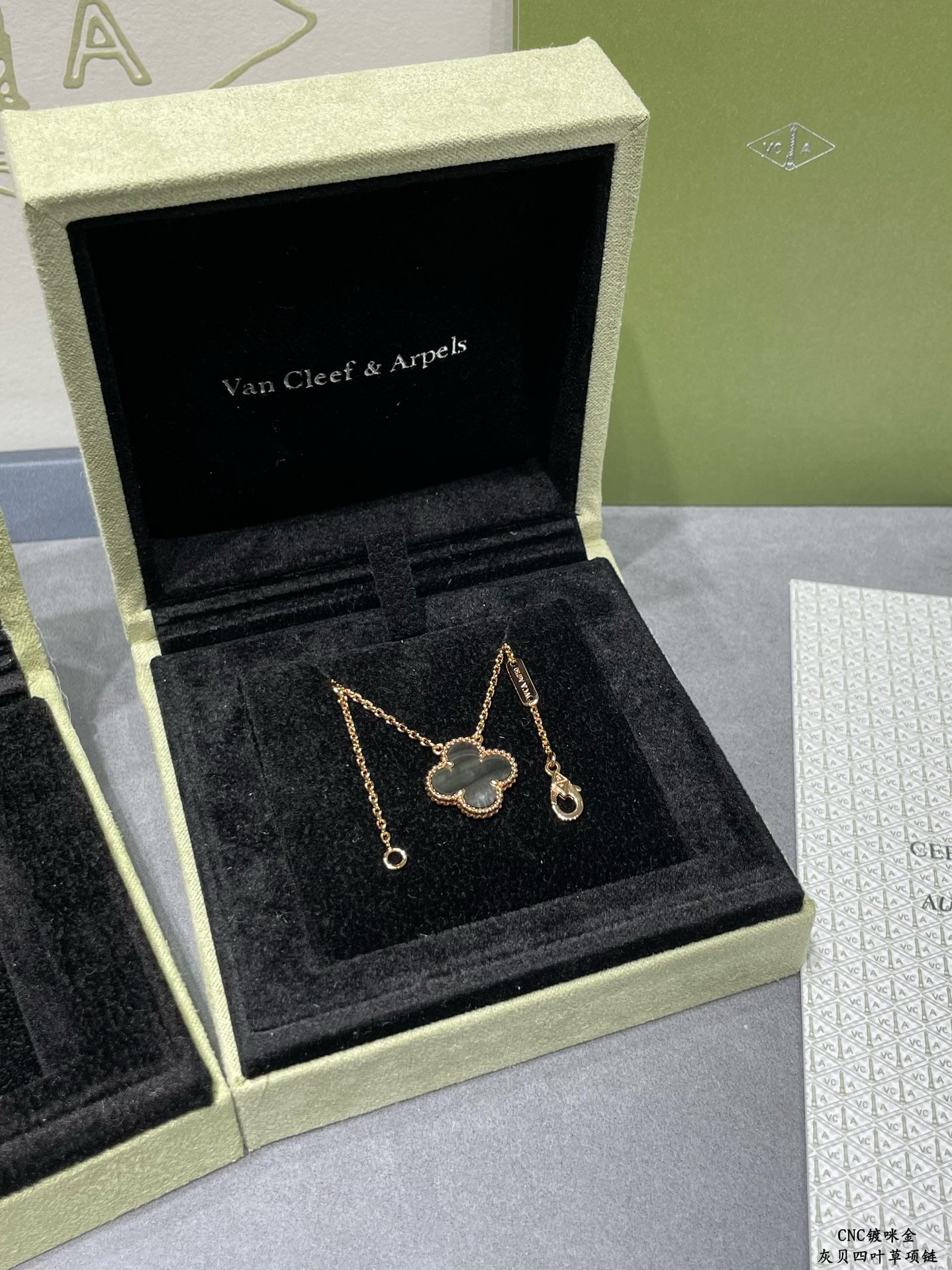 Van Cleef & Arpels accessories: clover pendant necklace and drop earrings in gift box