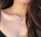 Van Cleef & Arpels accessories: blue enamel clover pendant necklace on model