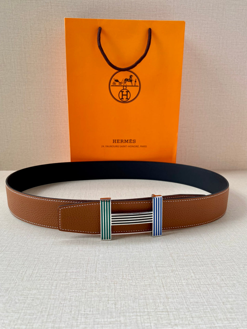 Brown leather belt with center striped green and blue buckle hardware