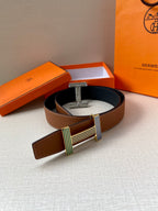 Brown leather belt with wide silver-tone buckle and striped green and blue accents