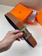 Brown leather belt with striped green, blue, and silver-tone buckle hardware