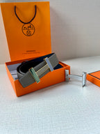 Hermes belt gray leather with striped buckle, shown in orange gift box with accessories