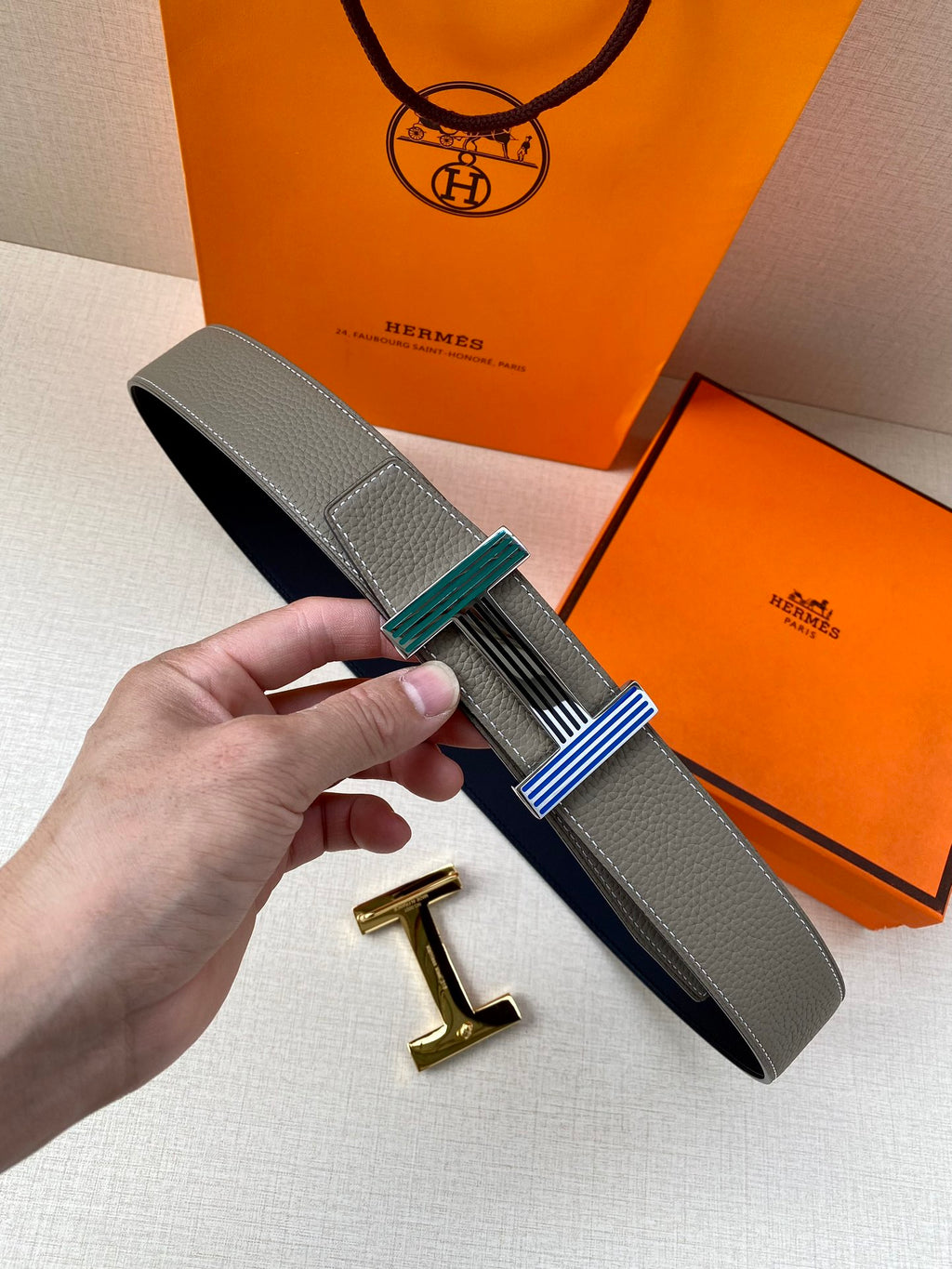 Hermes belt in gray leather with multicolor striped buckle and gold clasp hardware