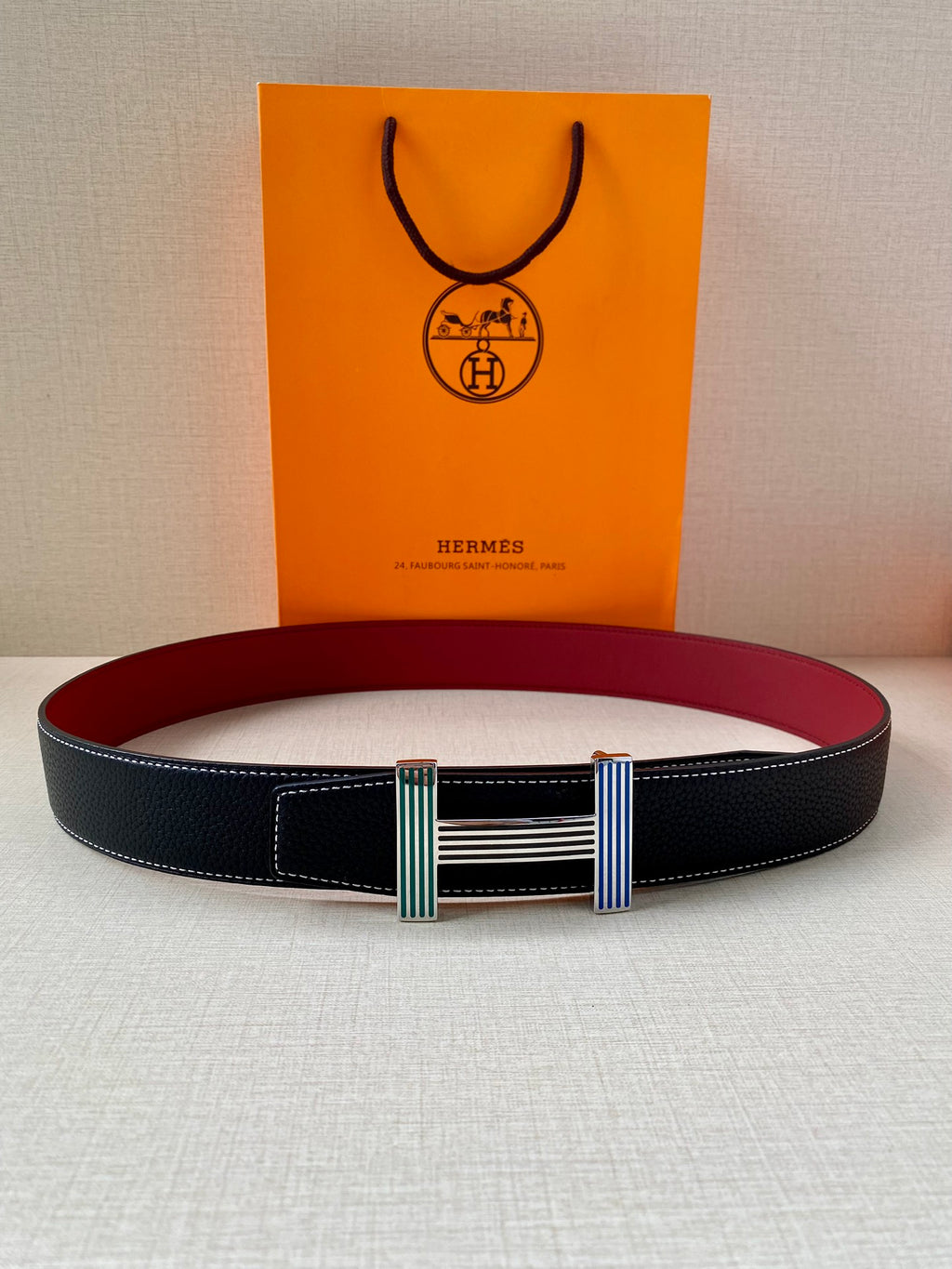 Hermes belt with dark blue leather strap and multicolor striped buckle