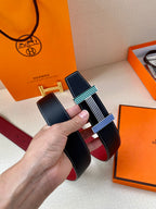 Hermes belt with dark blue leather strap and multicolor striped buckle held up