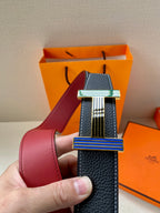 Hermes belt shown close-up with dark blue leather strap and striped rectangular buckle