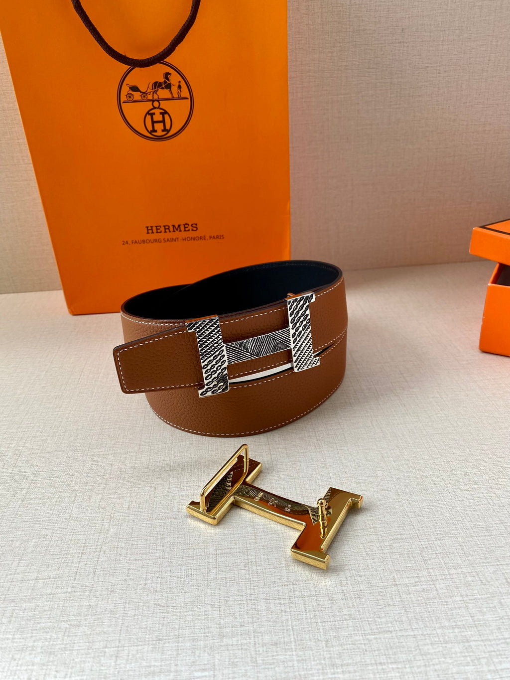 Hermes leather belt with brown strap and patterned silver-tone buckle