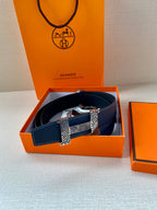 Navy blue leather belt with gold-tone buckle plates and textured center strap