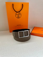Taupe leather belt with double square silver-tone buckle on a curved band