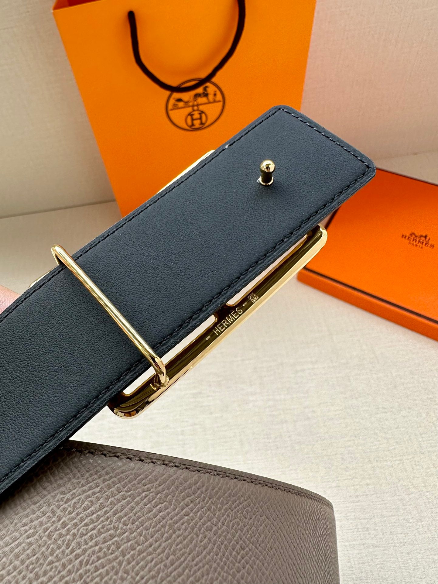 Taupe leather belt with gold-tone double buckle and textured strap
