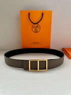 Taupe leather belt with gold-tone double square buckle, laid flat for view