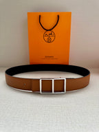 Hermes belt centered: tan leather strap and silver-tone square buckle