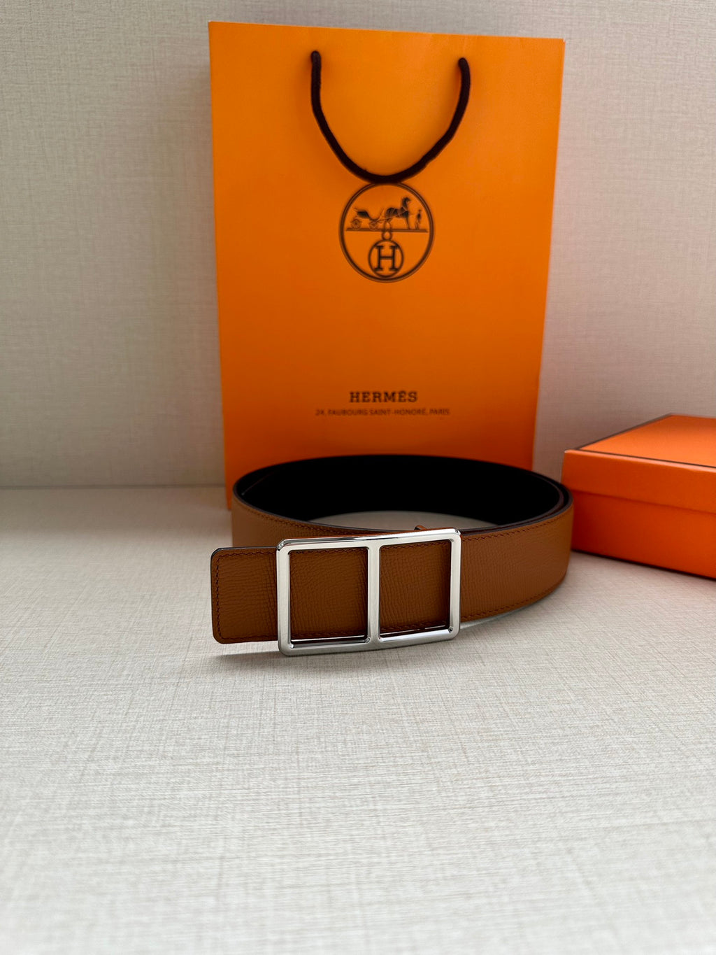Hermes belt with tan leather strap and silver-tone triple square buckle on box