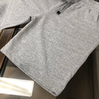Light gray sweat shorts with drawstring and side seam pocket