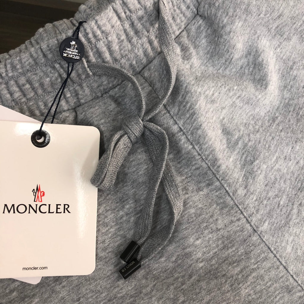 Light gray sweat shorts waistband with drawstring and MONCLER hang tag