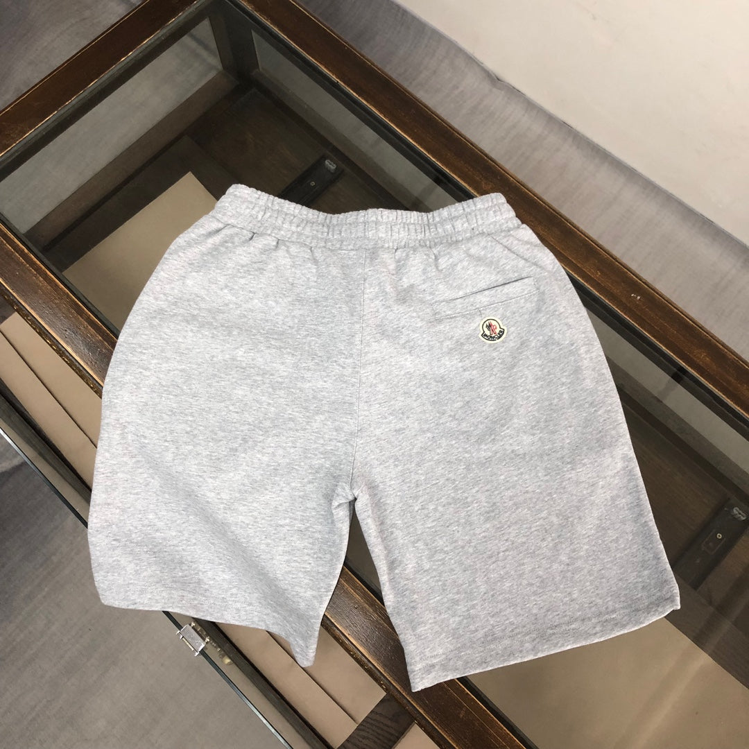 Light gray drawstring shorts with elastic waist and small logo patch