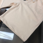 Stone Island shorts close-up showing diagonal seam on light cream fabric