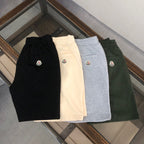 Set of four logo shorts in black, cream, light gray, and dark green