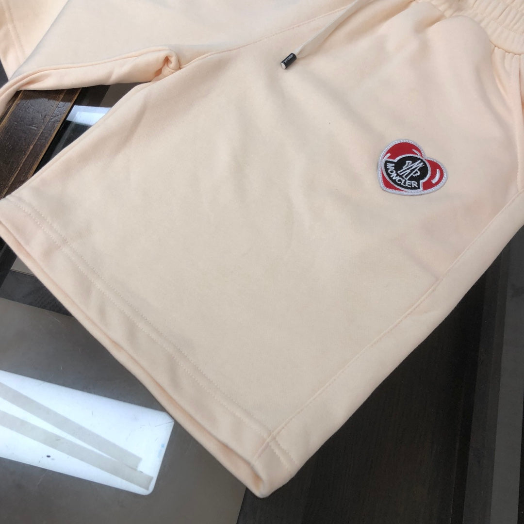 Stone Island cream shorts with red logo patch and drawstring cord