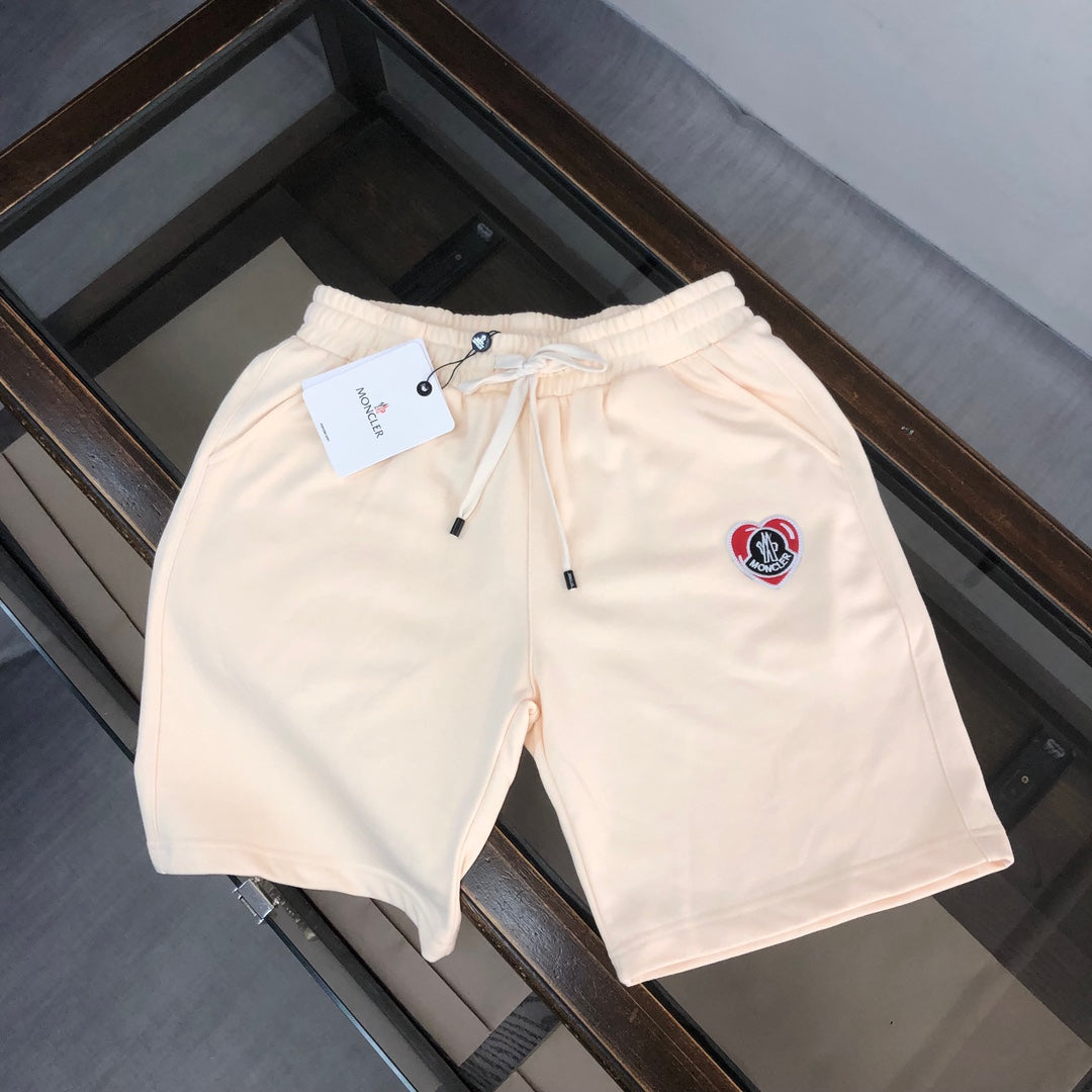 Stone Island cream drawstring shorts with elastic waistband and red logo patch