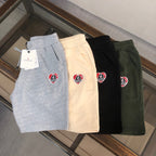 Stone Island shorts set: gray, cream, black, and dark green with logo patch