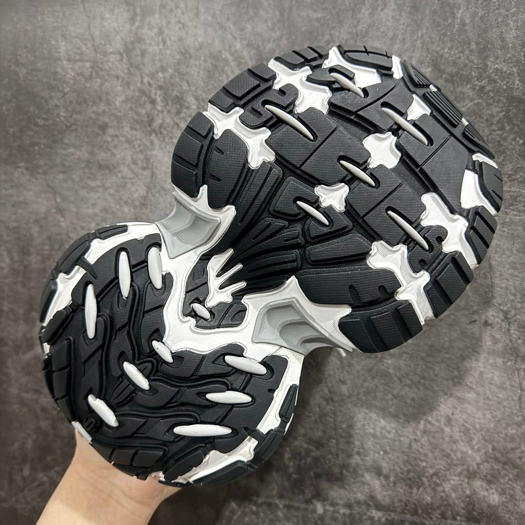 Unisex luxury sneaker outsole in black and gray with deep tread pattern