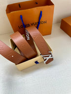 Louis Vuitton belt laid out with brown leather strap and large LV buckle