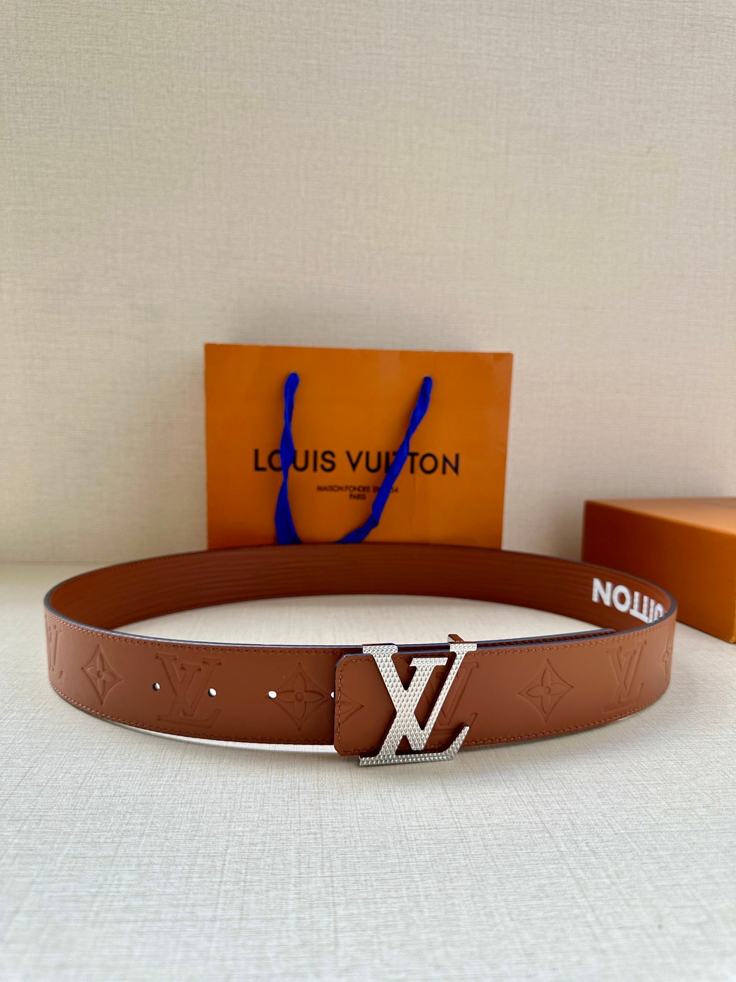 Louis Vuitton belt in brown with embossed pattern and silver-tone LV buckle