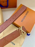Louis Vuitton belt strap close-up in brown with embossed texture and LV buckle