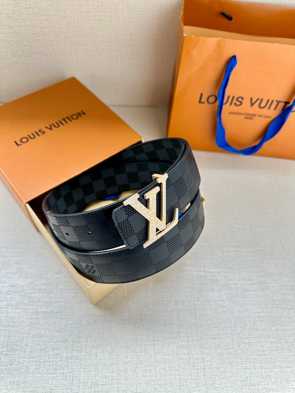 Louis Vuitton belt with dark blue checkered canvas and silver-tone LV buckle on dark strap